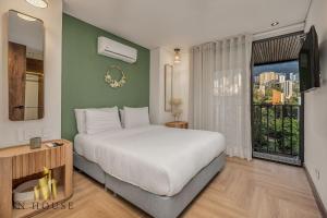 a bedroom with a large bed and a large window at Morph 1201 - Elegant/Modern Apt in Poblado in El Poblado +43 photos