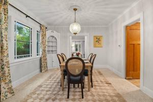 a dining room with a table and chairs at 1920s Cottage | Hot Tub | Game Room | Fire Pit in Rockford