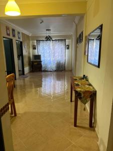 a living room with a table and a room with a floor at RumahCheMatsunami in Tanah Rata +1 photo