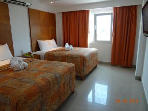 Postel nebo postele na pokoji v ubytování Suites Gaby Cancun