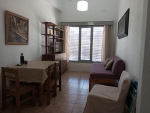 a living room with a table and a dining room at Artemisa in Piriápolis