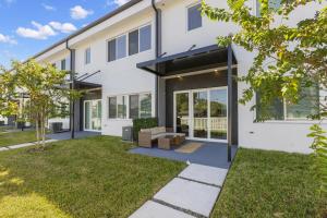 an exterior view of a house with a yard at NEW! Columbus Cove - Newly Built, Luxurious Home in Heart of Tampa in Tampa