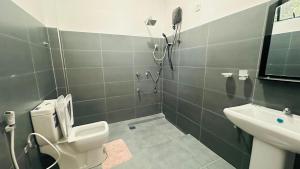 a bathroom with a toilet and a sink and a shower at Sigiri Rock View Lodge in Sigiriya +13 photos