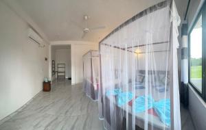 a room with a bed with a curtain at Sigiri Rock View Lodge in Sigiriya