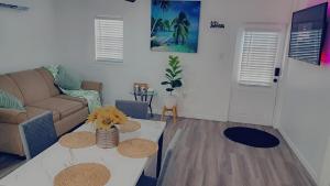 a living room with a couch and a table at Country Blue Getaway by the Ranch Fields in Auburndale