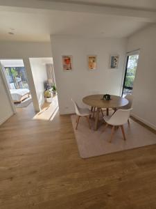 a living room with a wooden table and chairs at Apartment at the Beach in Red Beach