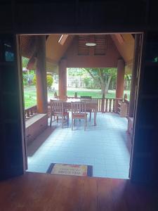 an open door to a patio with a table and chairs at Babazia Community in Pai