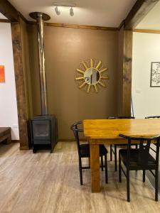 a dining room with a table and a wood stove at Aldea Molco Arrayan in Villarrica