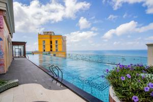 a swimming pool with a view of the ocean at Hayha Apartment by Haus Hospitality in Phu Quoc