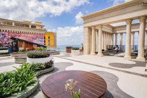 a patio with a table and a building at Hayha Apartment by Haus Hospitality in Phu Quoc