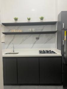 a kitchen with a counter with a sink and a stove at Apto Central primer piso 2 habitaciones in Apartadó