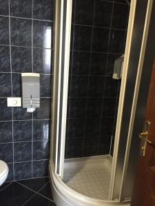 a bathroom with a shower and a toilet at Hotel Stari grad in Jajce +17 photos