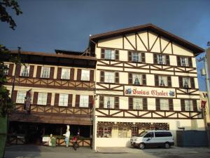 a building with a white van parked in front of it at Swiss Chalet in Angeles