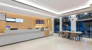 a lobby with a cafeteria with tables and chairs at City Comfort Inn Wuhan Ikea in Wuhan