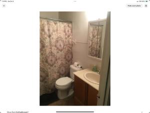 a bathroom with a toilet and a sink and a shower curtain at Contemporary Marine 2bed 1bath apartment in Kent in Kent +17 photos