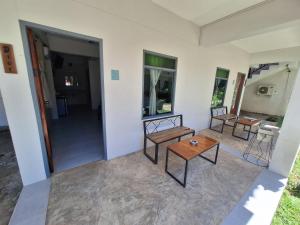 a living room with two chairs and a table at Sleep Pai Bed & Breakfast in Pai