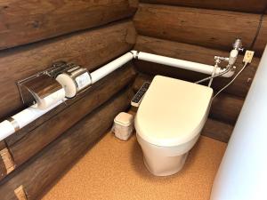 a bathroom with a toilet in a wooden wall at Mashuko Youth Hostel - Vacation STAY 01024v in Teshikaga