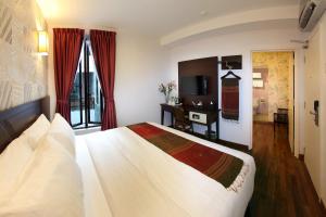 Postel nebo postele na pokoji v ubytování Hotel Richbaliz Selayang