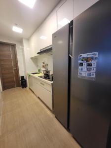 a kitchen with a stainless steel refrigerator in a room at Sky House 3BR in Samporo +12 photos