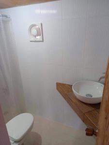a bathroom with a white toilet and a sink at Sea-Sky Blue Beach Resort at Malabrigo Lobo Batangas-SM01 in Batangas City