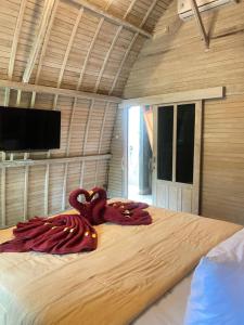 a large bed with an octopus on it in a room at Penginapan Gelar in Jembrana +13 photos