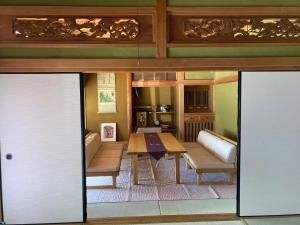 a living room with a table and a couch at 民泊絹家 in Izume