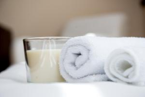 a towel and a glass of milk on a table at Luxe Stay in Târgu-Mureş +27 photos