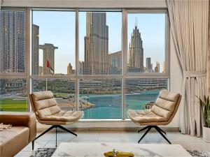 a living room with a view of the city at Panoramic Burj 5br Condo with Full Led & Fountain View in Dubai