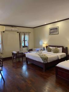 Postel nebo postele na pokoji v ubytování Luang Prabang Residence - The Boutique Villa