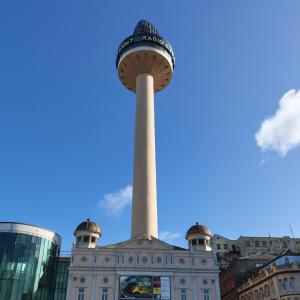 a obelisk in front of a building with a tower at Beacon Apart-hotel in Liverpool