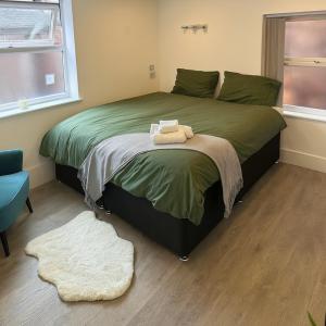a bedroom with a bed with two towels on it at Beacon Apart-hotel in Liverpool