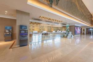 a large building with a lobby with vending machines at Yanji Yanbian International Hotel in Yanji