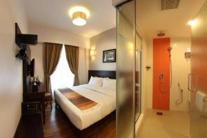 Postel nebo postele na pokoji v ubytování Hotel Richbaliz Selayang