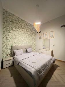 a bedroom with a large bed and a wall at Private Sea View Room in 3BR Downtown Apartment Direct Mall & Metro Access in Dubai