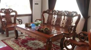 a room with two chairs and a wooden table at Favanhmai Hotel in Muang Phônsavan