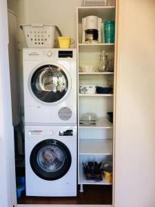 a washer and dryer sitting in a pantry at Gîte "Villa SIMONE" Vue Mer 180° CALME Terrasse couverte Jardin. in Carqueiranne