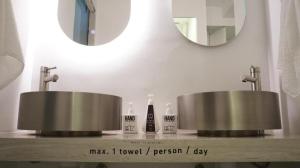 a bathroom with two sinks and a mirror at SLEEEP HKG Causeway Bay in Hong Kong +136 photos