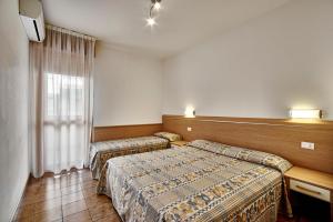 Posteľ alebo postele v izbe v ubytovaní Residence Columbia