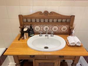 a sink on a wooden counter in a bathroom at Wandering Trout - Gourmet Stays in Mole Creek +19 photos