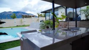 a house with a swimming pool and a table and chairs at Casa privada con piscina Ibarra in San José de Chaltura