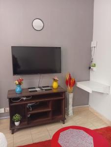 a living room with a flat screen tv on a wall at JO kitengela balozi road deluxe studio apartment in Kitengela 