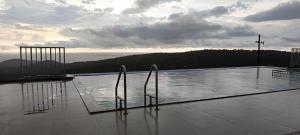 two chairs sitting on top of a swimming pool at Sea View Agro Resort in Srīvardhan