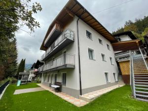 a large white building with balconies and a yard at FERIENWOHNUNGEN TANJA - dein Wohlfühlhaus in Kappl in Kappl +95 photos
