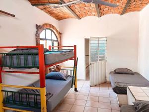 a room with three bunk beds in it at Beautiful Beach House in Lo De Marcos, Nayarit! in Lo de Marcos +81 photos