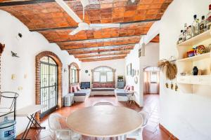 a living room with a table and chairs at Beautiful Beach House in Lo De Marcos, Nayarit! in Lo de Marcos