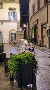 a group of benches in a courtyard at night at Ponticello in Caprarola