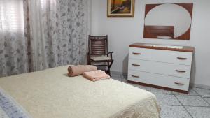 a bedroom with a bed and a dresser and a mirror at West Coast in Càbras