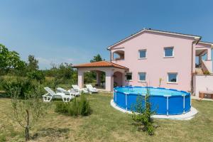 a villa with a swimming pool and a house at Apartment Elina in Labin