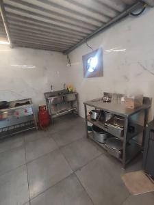 a kitchen with a table and a counter in a room at Classy Stay Villa - Karjat in Dhamni
