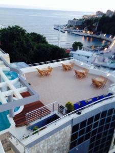 a view of a building with chairs and the ocean at Apartments Croma in Ulcinj